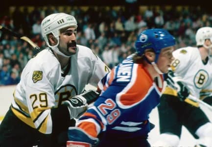 Boston Bruins left wing Jay Miller (left) battles Edmonton Oilers Reijo Ruotsalainen (29) at the Boston Garden.