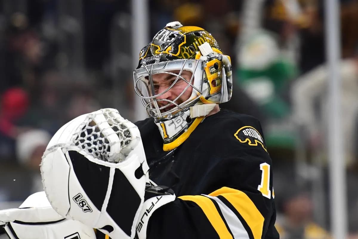 Boston Bruins goaltender Jeremy Swayman (1) puts on his gloves during the second period against the Vancouver Canucks at TD Garden.