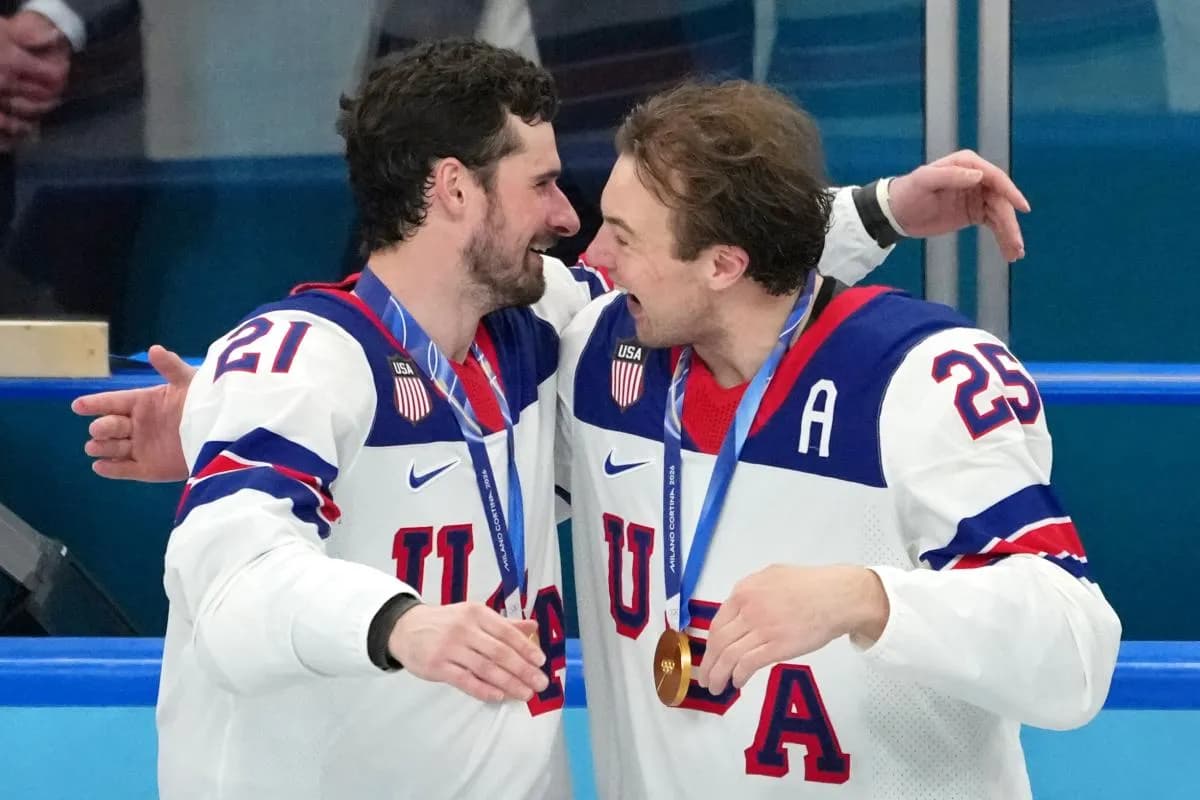 Dylan Larkin and Charlie McAvoy of the United States celebrates after winning against Canada in the gold medal game during the Milano Cortina 2026 Olympic Winter Games at Milano Santagiulia Ice Hockey Arena.