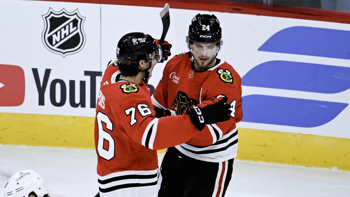 Chicago Blackhawks defenseman Bowen Byram (24) celebrates with left wing Nick Lardis (76) after he scored the game winning goal during the overtime period against the Minnesota Wild at the United Center.