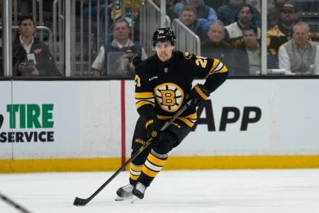 Boston Bruins defenseman Henri Jokiharju (20) skates with the puck during the first period of the game against the Detroit Red Wings at TD Garden.