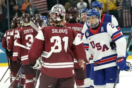 Charlie McAvoy of United States shakes hands with Arturs Silovs of Latvia after the match in men's ice hockey group C play during the Milano Cortina 2026 Olympic Winter Games at Milano Santagiulia Ice Hockey Arena.