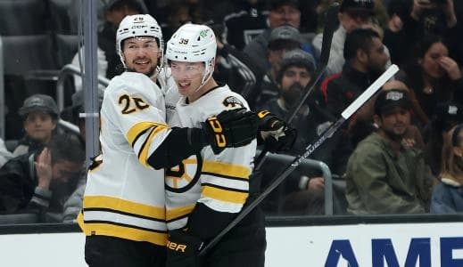 Boston Bruins center Morgan Geekie (39, right) celebrates with defenseman Andrew Peeke (26) after scoring a goal during the third period against the Los Angeles Kings at Crypto.com Arena.