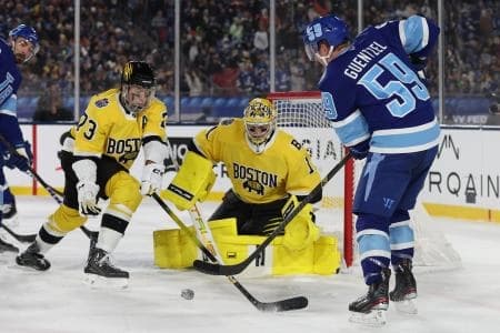 Tampa Bay Lightning center Jake Guentzel (59) shoots the puck as Boston Bruins goaltender Jeremy Swayman (1) and defenseman Charlie McAvoy (73) defend during the second period in the 2026 Stadium Series ice hockey game at Raymond James Stadium.