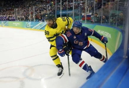 William Nylander (88) of Sweden and Charlie McAvoy (25) of the United States in action in a men's ice hockey quarterfinal during the Milano Cortina 2026 Olympic Winter Games at Milano Santagiulia Ice Hockey Arena.