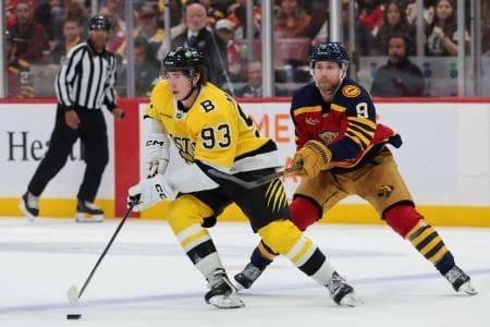 Boston Bruins center Fraser Minten (93) moves the puck against Florida Panthers center Sam Bennett (9) during the second period at Amerant Bank Arena.