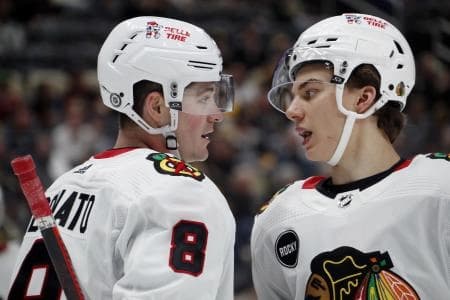 Chicago Blackhawks center Ryan Donato (8) and center Connor Bedard (right) talk before a face-off against the Pittsburgh Penguins during the third period at the PPG Paints Arena. Chicago won 4-2.