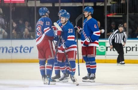 New York Rangers defenseman Adam Fox (23) celebrates his goal with defenseman Braden Schneider (4) and left wing Alexis Lafreniere (13) during the second period against the Vancouver Canucks at Madison Square Garden.