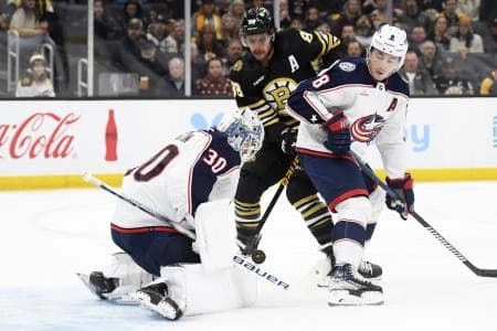 Columbus Blue Jackets goaltender Spencer Martin (30) makes a save in front of Boston Bruins right wing David Pastrnak (88) and defenseman Zach Werenski (8) during the first period at TD Garden.
