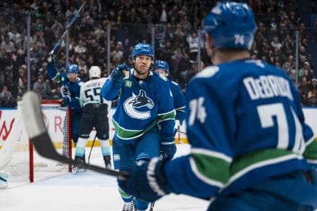 Vancouver Canucks forward Kiefer Sherwood (44) and forward Jake DeBrusk (74) celebrate Sherwood's goal against the Seattle Kraken in the second period at Rogers Arena.