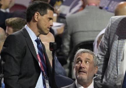 Boston Bruins general manager Don Sweeney (left) and president Cam Neely discuss during the second round of the 2022 NHL Draft at the Bell Centre.