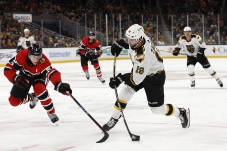 Boston Bruins center Pavel Zacha (18) lets go with a shot past Chicago Blackhawks defenseman Connor Murphy (5) during the third period at TD Garden.