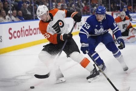 Philadelphia Flyers defenseman Rasmus Ristolainen (55) battles with Toronto Maple Leafs forward Easton Cowan (53) to get control of the puck during the third period at Scotiabank Arena.