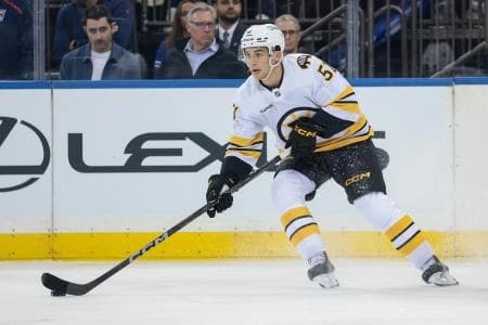 Boston Bruins center Matthew Poitras (51) carries the puck during the first period of a preseason game against the New York Rangers at Madison Square Garden.