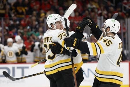 Boston Bruins defenseman Charlie McAvoy (73) celebrates with teammates after scoring a goal against the Washington Capitals during the second period at Capital One Arena
