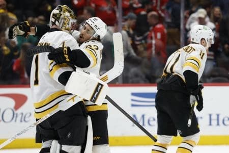 Boston Bruins goaltender Jeremy Swayman (1) celebrates with Bruins center Marat Khusnutdinov (92) after their shootout win against the Washington Capitals at Capital One Arena.