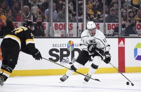 Los Angeles Kings center Anze Kopitar (11) skates with the puck while Boston Bruins center Patrice Bergeron (37) defends during the second period at TD Garden.