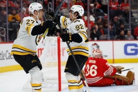 Boston Bruins center Marat Khusnutdinov (92) receives congratulations from defenseman Hampus Lindholm (27) after scoring in the third period against the Detroit Red Wings at Little Caesars Arena