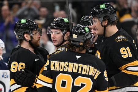 Boston Bruins center Fraser Minten (93) (center) celebrates a goal against the Winnipeg Jets with teammates during the third period at TD Garden