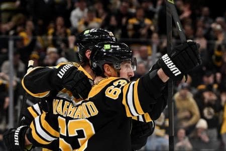 Boston Bruins left wing Brad Marchand (63) celebrates with center Elias Lindholm (28) after scoring a goal against the Toronto Maple Leafs during the first period at the TD Garden