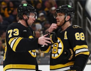 Boston Bruins defenseman Charlie McAvoy (73) talks with right wing David Pastrnak (88) during the third period against the Toronto Maple Leafs at TD Garden.