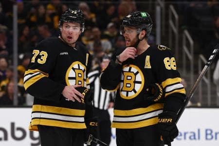 Boston Bruins defenseman Charlie McAvoy (73) talks with right wing David Pastrnak (88) during the third period against the Toronto Maple Leafs at TD Garden.