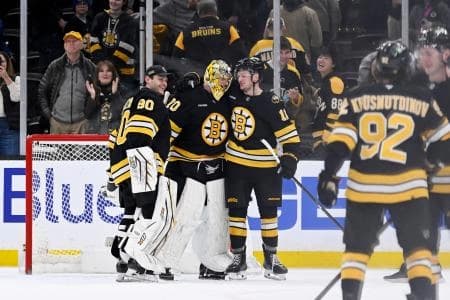 Boston Bruins goaltender Joonas Korpisalo (70) celebrates defeating the Columbus Blue Jackets with goaltender Michael DiPietro (80) and center Casey Mittelstadt (11) at TD Garden.