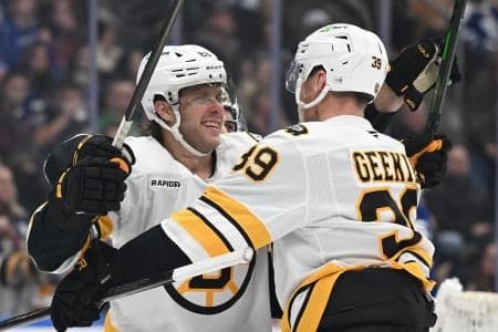 Boston Bruins forward David Pastrnak (88) celebrates with forward Morgan Geekie (39) after scoring a goal against the Toronto Maple Leafs in the second period at Scotiabank Arena