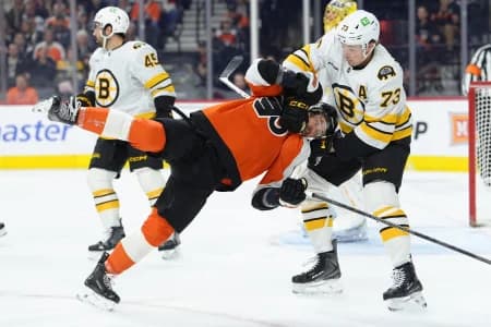 Boston Bruins defenseman Charlie McAvoy (73) grabs Philadelphia Flyers right wing Travis Konecny (11) in the first period at Xfinity Mobile Arena.