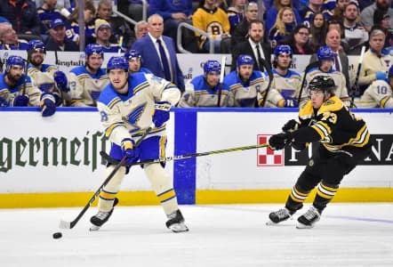 St. Louis Blues center Robert Thomas (18) passes the puck as Boston Bruins defenseman Charlie McAvoy (73) defends during the first period at Enterprise Center