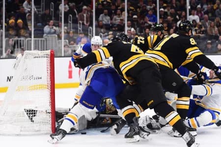 Boston Bruins goaltender Joonas Korpisalo (70) tries to tie up a loose puck during the second period against the Buffalo Sabres at TD Garden.