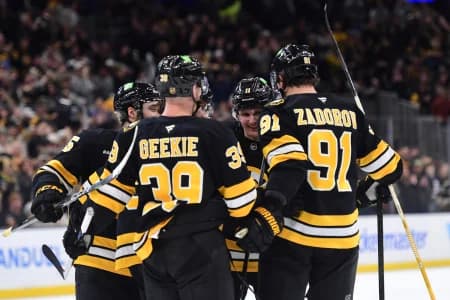 Boston Bruins center Morgan Geekie (39), defenseman Nikita Zadorov (91), center Casey Mittelstadt (11) and defenseman Jonathan Aspirot (45) celebrate a goal by center Pavel Zacha (18) during the third period against the Minnesota Wild at TD Garden.