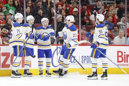 Buffalo Sabres center Josh Norris (9) celebrates with teammates after scoring against the Chicago Blackhawks during the first period at United Center.