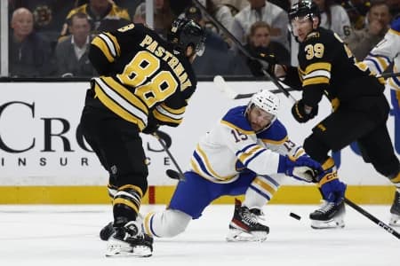 Buffalo Sabres right wing Justin Danforth (15) tries to block a shot by Boston Bruins right wing David Pastrnak (88) during the second period at TD Garden.