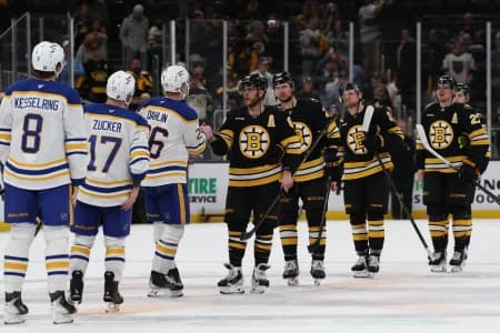 Boston Bruins right wing David Pastrnak (88) leads the Bruins through the Bruins as he shakes hands with Buffalo Sabres defenseman Rasmus Dahlin (26) after game six of the first round of the 2026 Stanley Cup Playoffs at TD Garden.