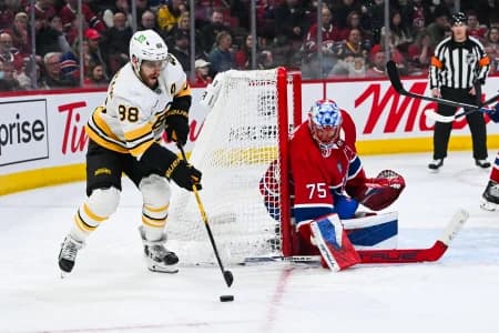 Boston Bruins right wing David Pastrnak (88) plays the puck against Montreal Canadiens goalie Jakub Dobes (75) during the third period at Bell Centre.